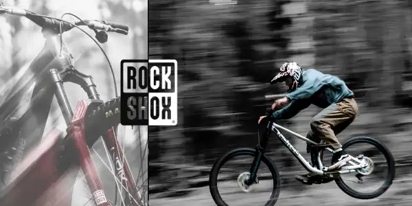 Mountain biker με ανάρτηση RockShox σε γρήγορη δασική διαδρομή